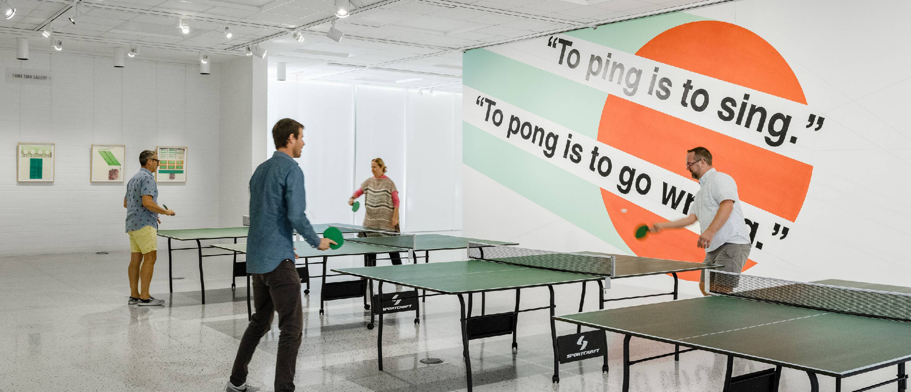 People playing ping pong in the gallery