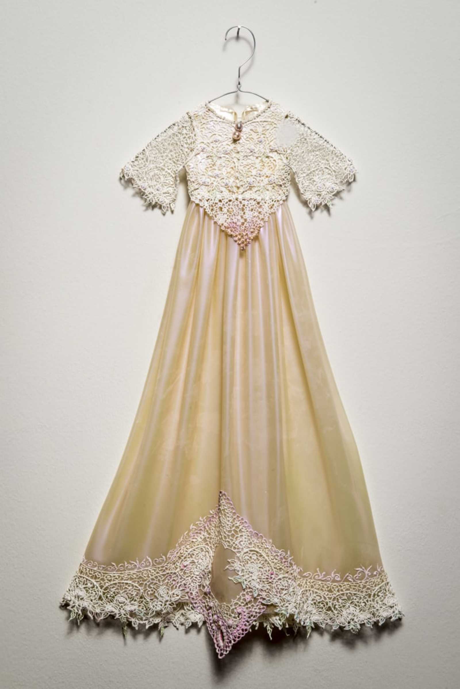 Pat Lasch, A Life Blessed: Christening Dress, H.V., Four Pregnancies, Two Births, 2014, acrylic paint, baroque pearls, photograph by David Plakke