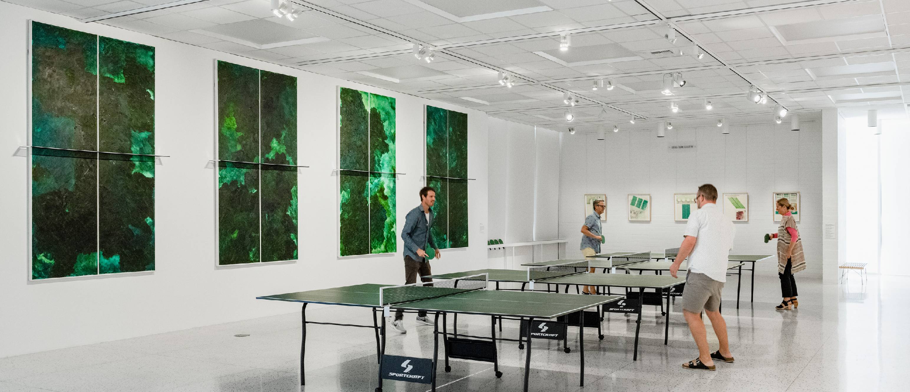 People playing ping pong in the gallery