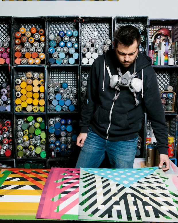 Ryan Campbell in his studio looking at one of his pattern