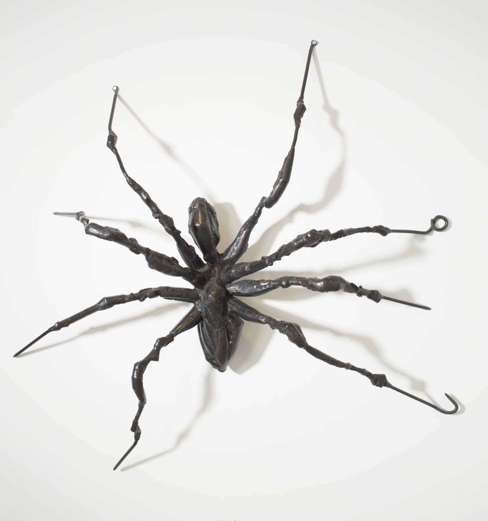 louise bourgeois's spider on a wall in a gallery